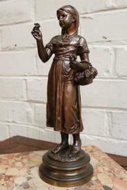 Bronze little lady with flowers signed by the maker