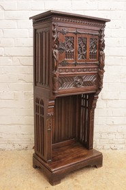 Narrow figural oak cabinet