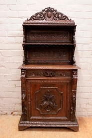 Narrow oak hunt cabinet.