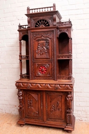 Oak breton figural cabinet