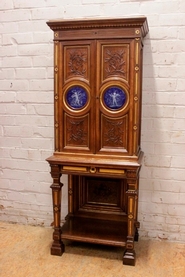 Walnut renaissance cigar cabinet with porcelain plaques stamped Godin